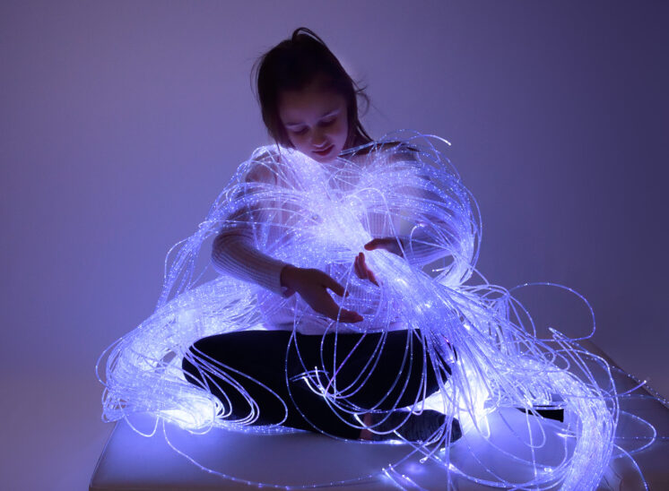 Playlearn product, young girl intrigued by glowing fiber optic product